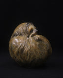 Bronze sculpture of a sloth curled up in a ball