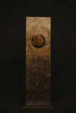 Bronze sculpture of bird in a sculptural form plaque on a black background.