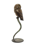 Bronze owl sculpture on a white background