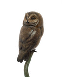 Bronze owl sculpture on a white background