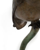 Bronze owl sculpture on a white background featuring signature