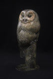 Bronze sculpture of a tawny owl perched