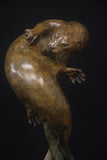 Bronze sculpture of a bear on a black background