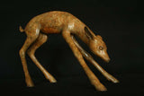Bronze sculpture of a deer on a black background