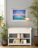 White bookshelf with books, framed artwork on the wall, and potted plants in a room.