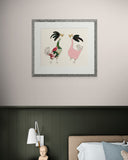 Framed artwork of cartoon roosters on a wall above a bed.