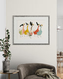 Framed artwork of colorful ducks on a wall above a gray armchair.