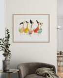 Framed artwork of colorful birds on a wall above a gray armchair.