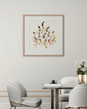 Framed artwork of birds on a wall above a modern dining table with chairs.