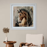 Framed artwork of a horse on a wall above a chair and side table.