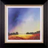 A framed  landscape painting of a vast golden field under a dramatic sky, with a dark stormy blue-purple cloud formation on the left and a pale yellow horizon. A small white house with a red roof sits near a line of dark trees on the horizon.