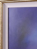 Close-up of a framed art print featuring a textured blue and purple abstract canvas, bordered by a white mat and a gold frame.