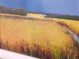 Artwork of a vibrant yellow meadow and blue sky with white moulding.