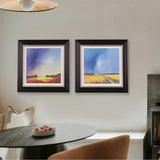 Two framed landscape artworks in a kitchen