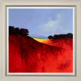 Framed painting of a landscape with red fields and blue sky.