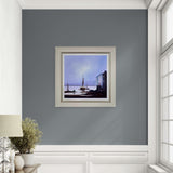Framed artwork on a gray wall with a window to the right