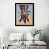 Framed artwork of a horse's face on a wall above a sofa in a living room.