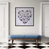 Framed heart-shaped artwork with handprints above a blue bench in a room with checkered floor.