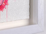 Close-up of a framed picture with a textured white border