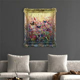 framed abstract art with butterflies on a wall above a grey sofa with cushions