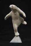 White polar bear figurine on a black background