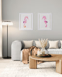 Living room with a gray sofa, wooden coffee table, and framed pink seahorse art on the wall.