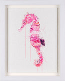 Framed artwork of a pink seahorse on a white background