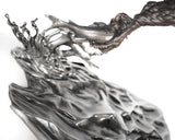 Metallic sculpture of a dragon and fish on a white background