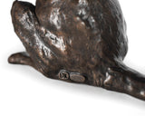 Bronze sculpture of a hand holding a heart on a white background
