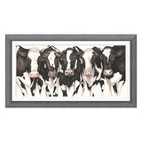Framed artwork of four black and white cows on a white background