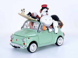 A mint green toy convertible car with cartoon characters piled in the back, including a white dog, a black-and-white dog, and a character with a red hat, photographed on a clean white studio background.