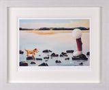 A framed art print depicting a small dog standing on rocks in a calm body of water, facing a large white-headed figure in a red coat. The print is matted in white and housed in a light gray textured frame.
