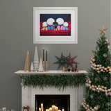 Decorated Christmas mantel with candles, trees, and a framed picture on a gray wall.