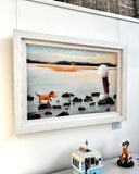 Person with their dog on rocks in the sea artwork