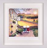A framed art print depicting a charming village scene with two children looking at a black dog by a pub, surrounded by a wide white frame.