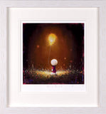 A framed art print featuring a whimsical painting of a small figure holding a glowing golden balloon above a dark, grassy landscape. The print is presented with a wide white mat and a light-colored textured frame.