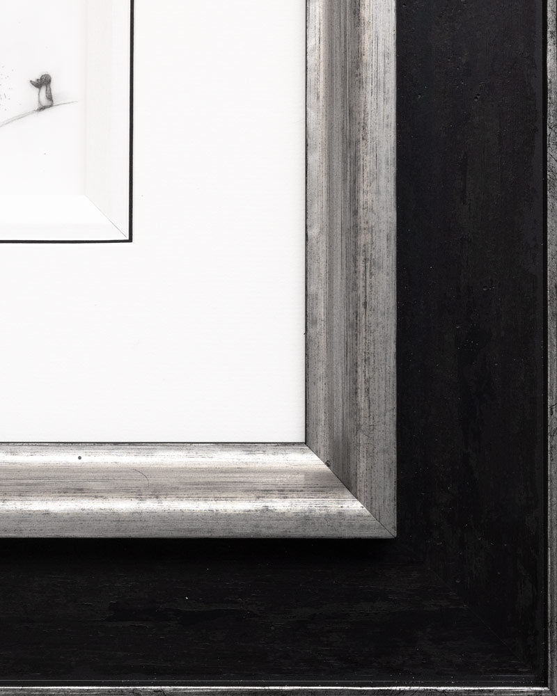 Close-up of a silver picture frame on a black background