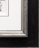 Close-up of a framed picture with a detailed wooden frame.