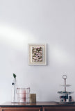 Floral artwork with pink, white and plum colours on a matalic background