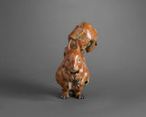 Bronze sculpture of a squirrel with a nut on a grey background