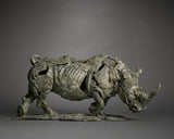 Bronze sculpture of a rhinoceros on a gray background