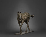 Bronze sculpture of a horse on a dark gray background