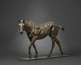 Bronze sculpture of a horse on a gray background