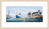 A panoramic landscape art print depicting a coastal village with colorful houses, a lighthouse, and a fishing boat on a sandy shore, presented with a light whitewashed oak frame