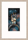 A framed art print featuring a whimsical illustration of a cottage on a stone bridge under a starry night sky, presented with a light wood frame.