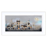 Framed artwork of a village scene with houses and streetlights on a gray background