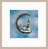 A square art print featuring a whimsical winter scene of a crescent moon floating in the sky, with snow-covered houses and a lighthouse inside, surrounded by a wide white mount and a light oak textured frame.