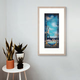 Framed artwork of a lighthouse scene on a wall with potted plants on a small table below.
