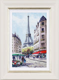 Framed artwork of a Parisian street scene with the Eiffel Tower.