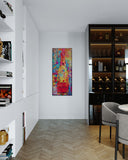 Modern interior with a colorful abstract painting on a white wall, a wine cabinet, and a chair.